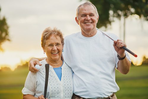 Senior couple playing golf outdoors