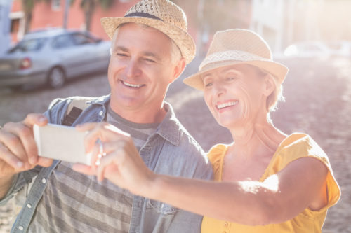 A couple looking at a phone together after having cataract surgery