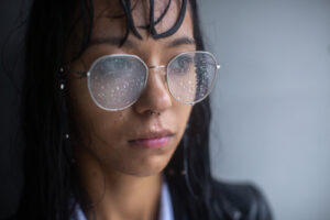 woman in glasses who is standing in the rain