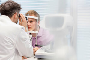 eye doctor performing an eye exam on patient 