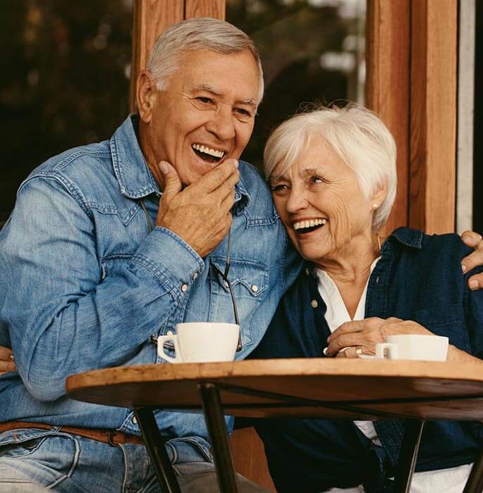 Couple Laughing at a Coffee Table