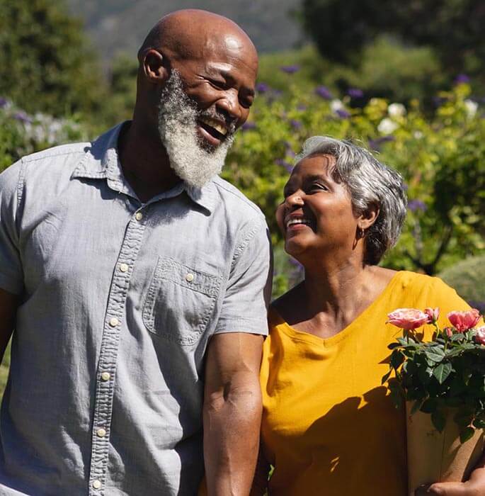 Couple Laughing While Walking in a Park